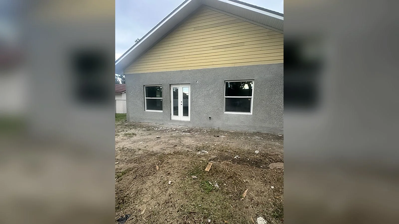 Rear elevation of the finished Lurline home with french doors and windows in