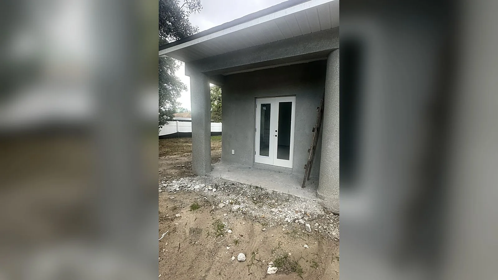 Covered rear porch of the Lurline home, printed columns and french doors