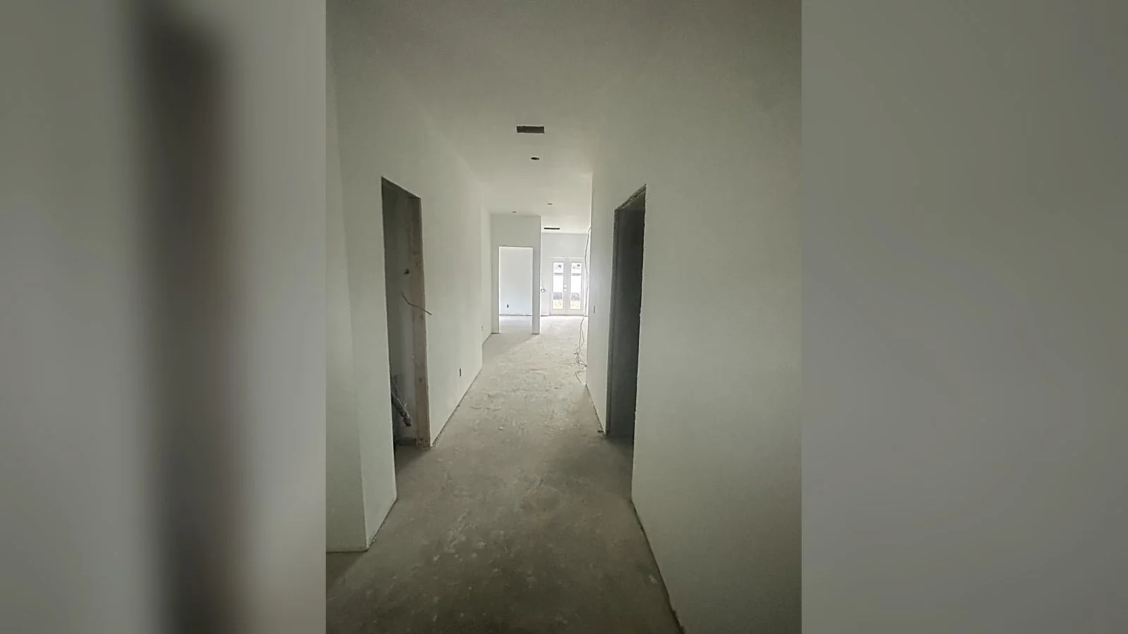 Inside the Lurline home: finished hallway running to the rear doors